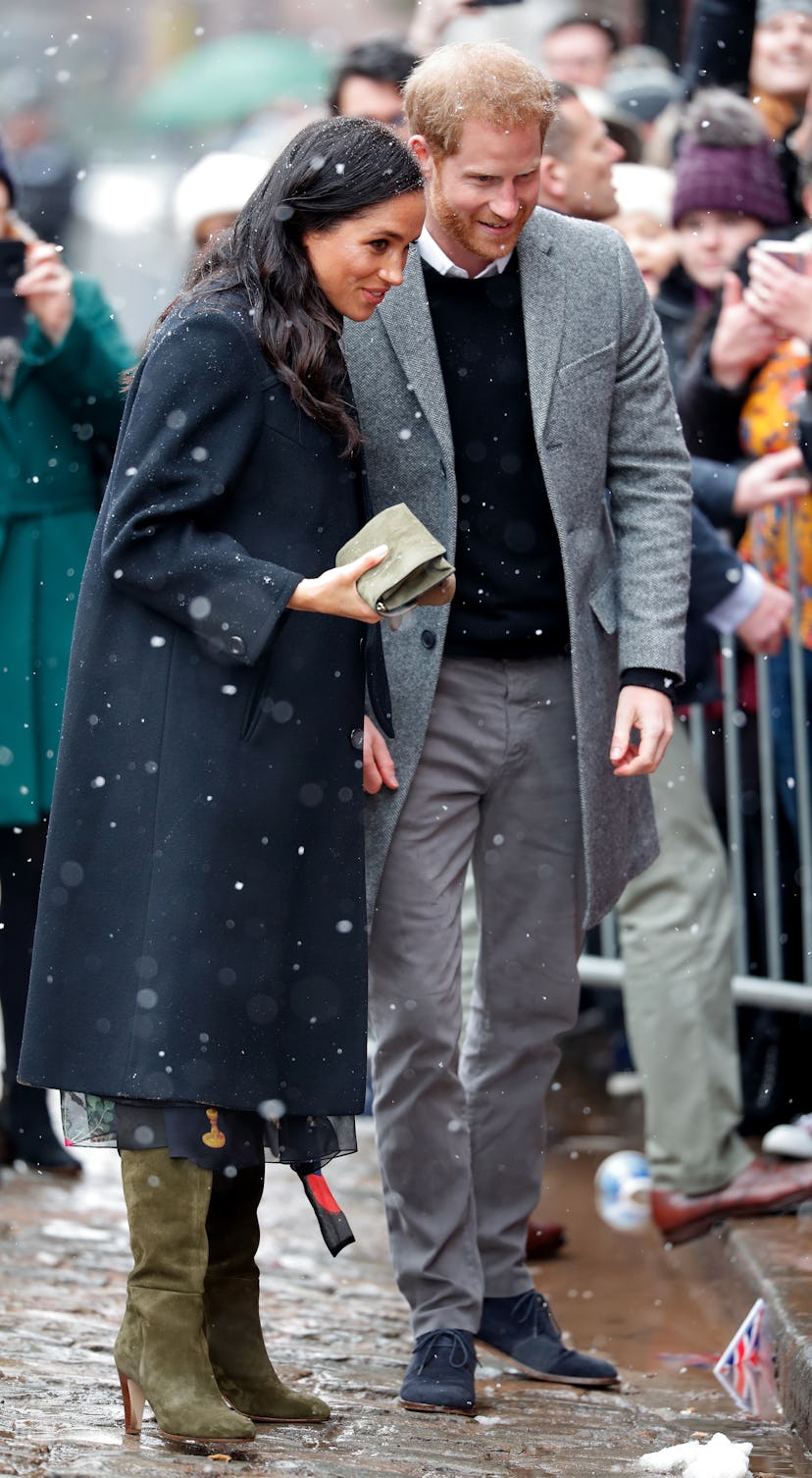 Prince Harry and Meghan Markle talk to royal fans in the snow in Bristol, Feb. 2019.