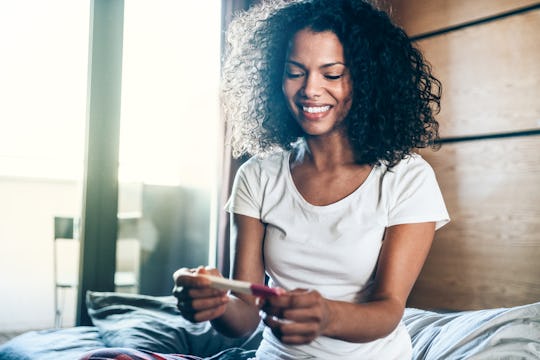 woman looking at pregnancy test