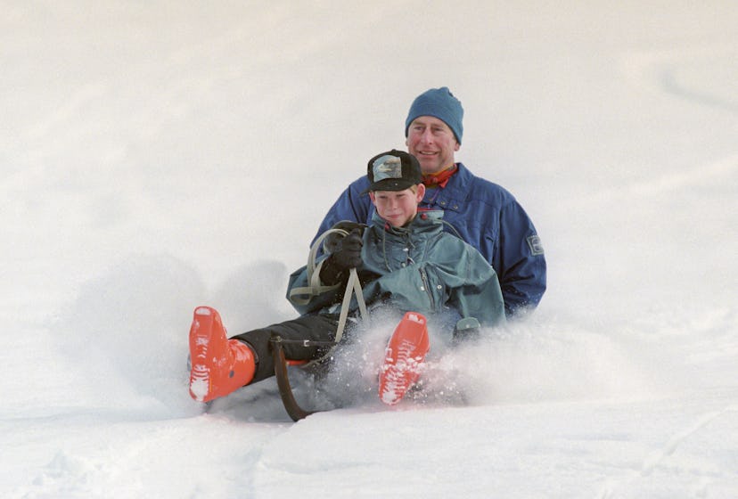 Prince Charles goes sledding with Prince Harry in 1997.