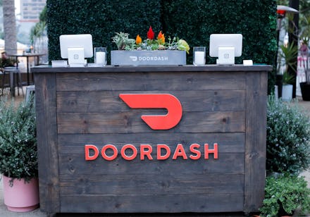 A big wooden desk with DoorDash text and logo