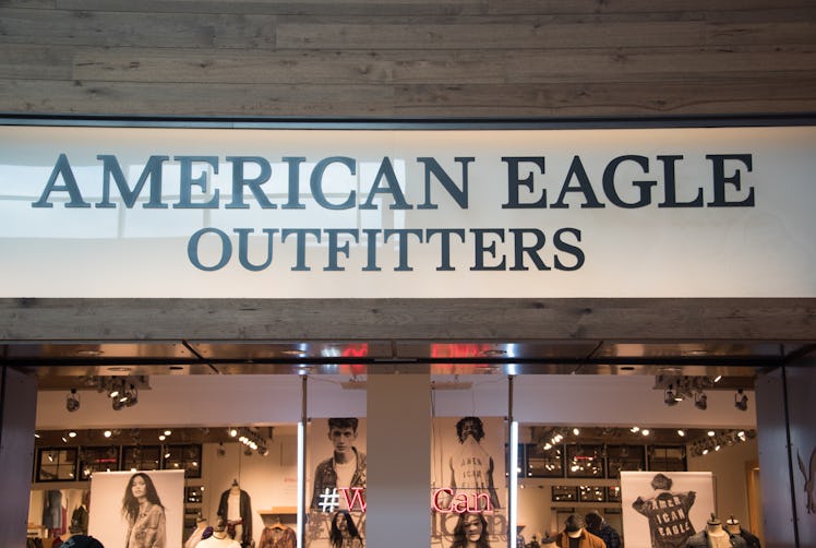 The American Eagle storefront has a big sign and posters of the models.