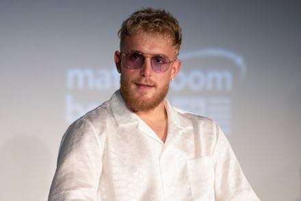 Jake Paul in a white silk button up shirt and sunglasses