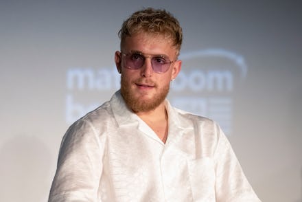 Jake Paul in a white silk button up shirt and sunglasses 