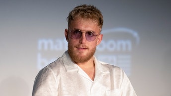 Jake Paul in a white silk button up shirt and sunglasses 