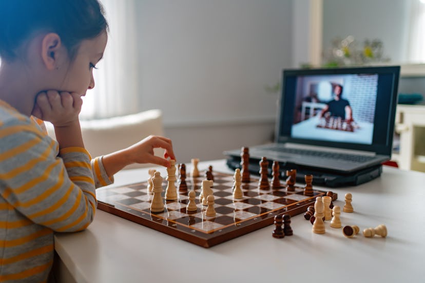 A kid playing chess on zoom