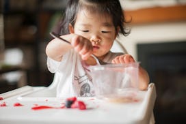 asian toddler girl eating snack