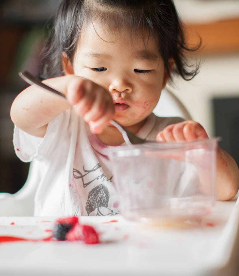 asian toddler girl eating snack