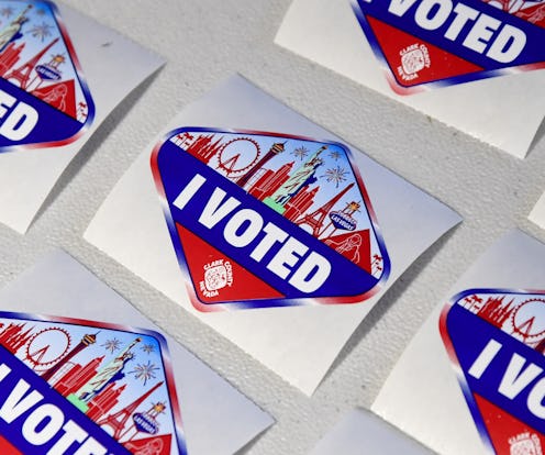"I voted" stickers on a white tabletop. Here's how a candidate wins electoral votes in the electoral...