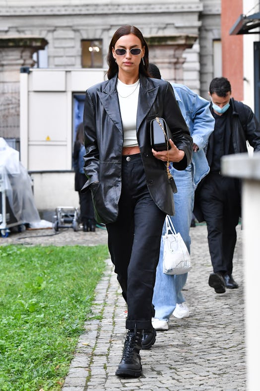 Irina Shayk wearing a black leather blazer, black cuffed trousers paired with combat boots