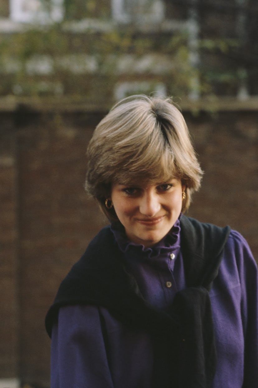 Princess Diana wears a sweater tied around her shoulders.