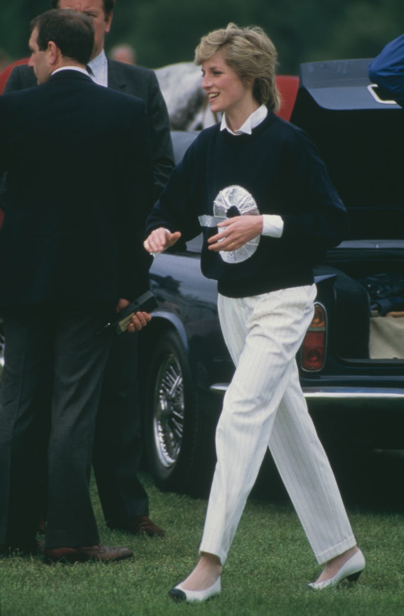 Princess Diana wears a navy sweater.
