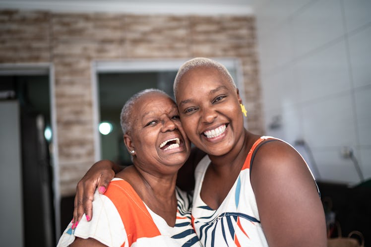 A happy mother and daughter hug while wearing matching outfits. 