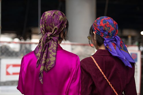 Two girls with silk scarves over their hair