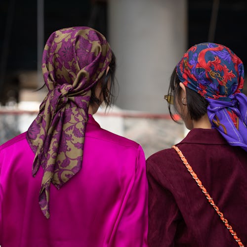 Two girls with silk scarves over their hair