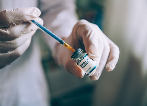 A scientist draws covid vaccine from a vial with a needle. Doctors want to bust these 6 myths about ...