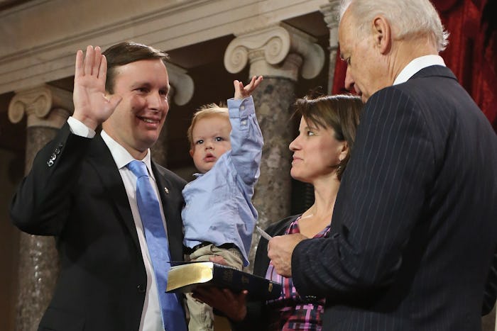 Then-Vice President Joe Biden swears in Chris Murphy into the U.S. Senate in 2013 while he holds his...