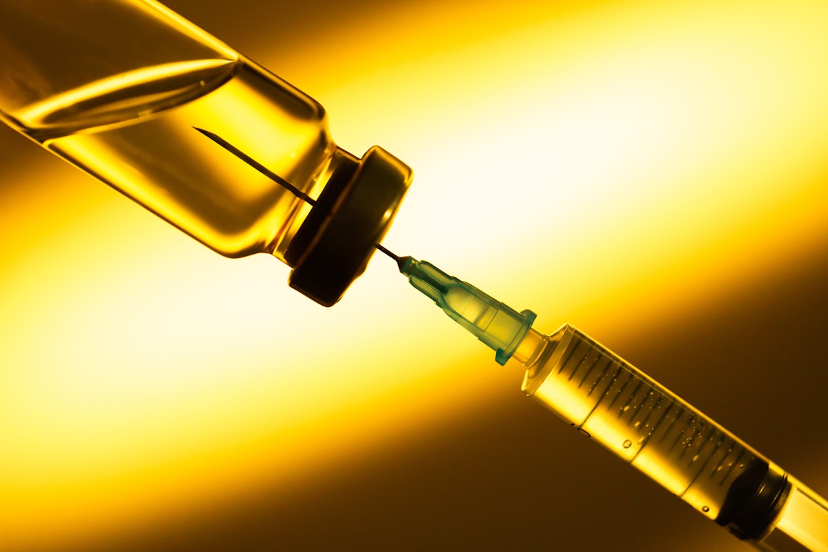 A needle in a vaccine tube distributing a COVID-19 vaccine. 