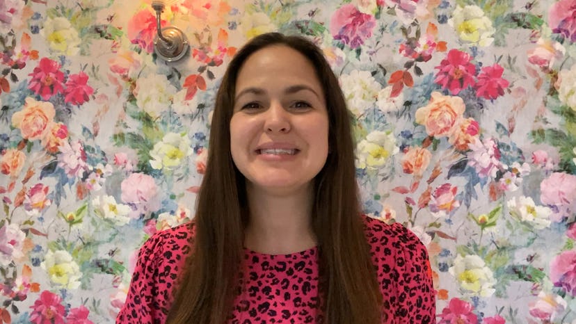 Giovanna Fletcher pictures against a blue and pink floral background, wearing a pink and black patte...