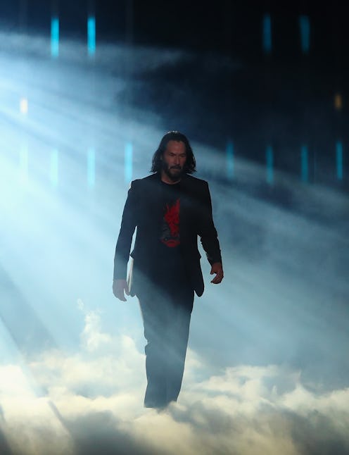 Keanu Reeves walking on stage during a Cyberpunk 2077 event