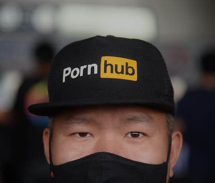 Man wearing a Pornhub hat.