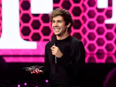 David Dobrik, YouTuber behind "The Hundred Thousand Dollar Puzzle," stands with a microphone at the ...