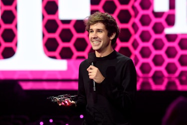 David Dobrik, YouTuber behind "The Hundred Thousand Dollar Puzzle," stands with a microphone at the ...
