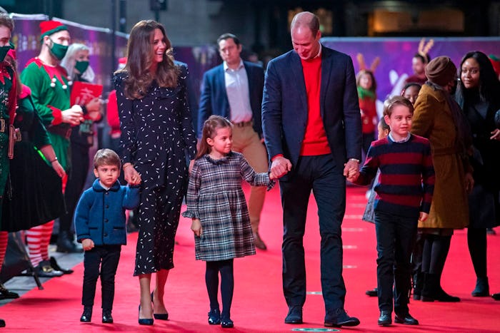 The Cambridge family walks the red carpet.