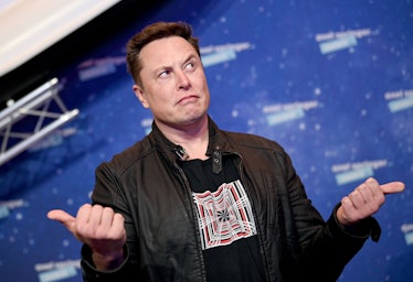 Elon Musk in a black jacket with thumbs up an tilted 