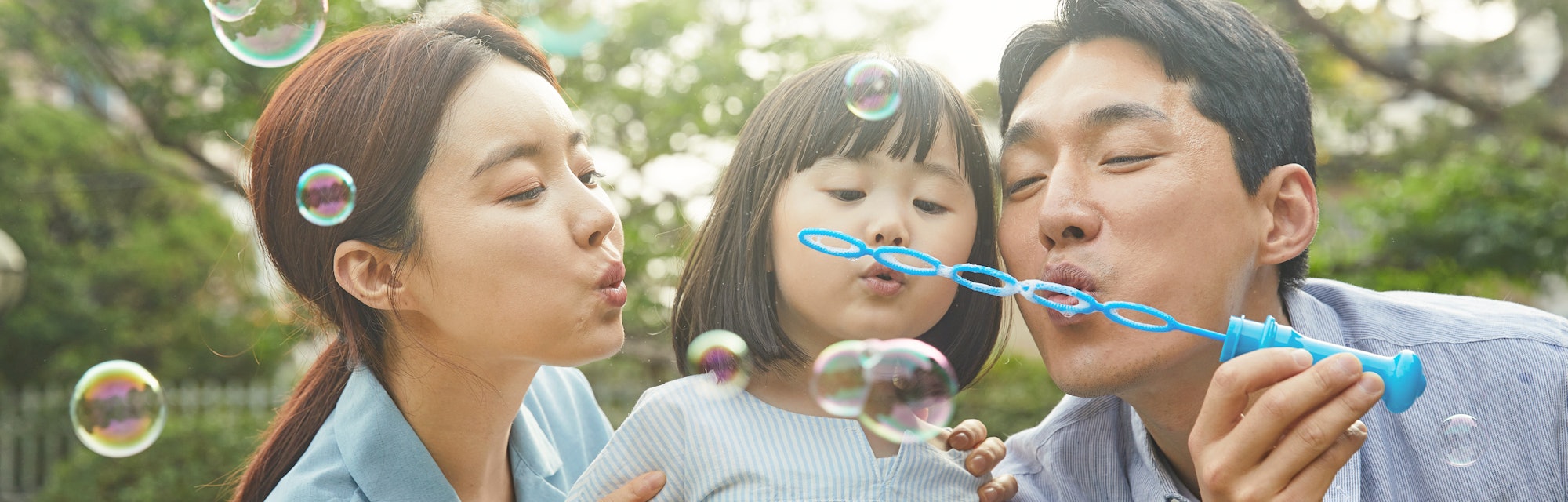 family blowing bubbles