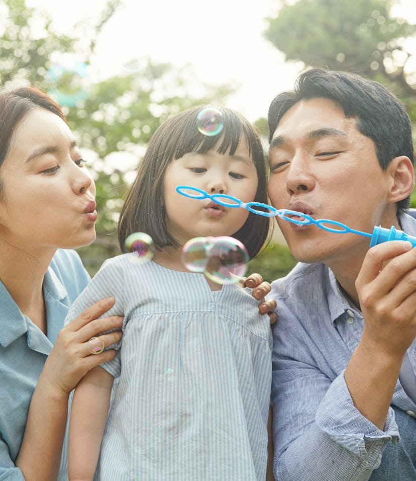 family blowing bubbles