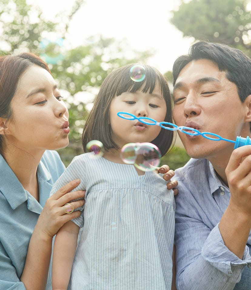 family blowing bubbles