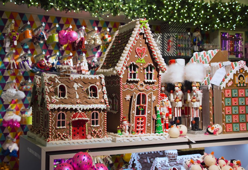 two large gingerbread houses next to a three nutcrackers.