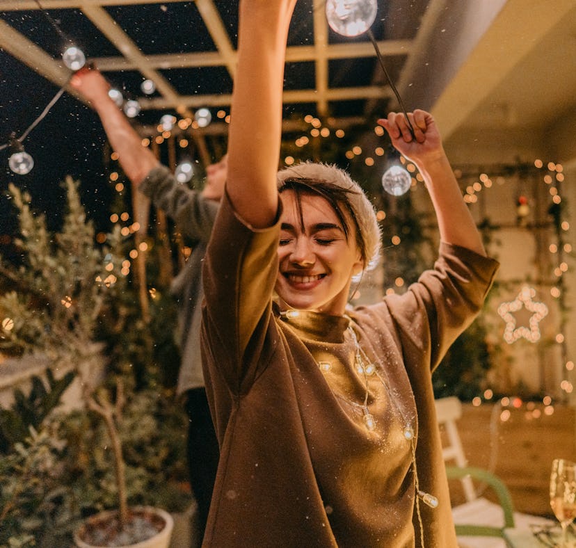 Woman celebrates finding the perfect gift for her partner for the holidays, based on their zodiac si...