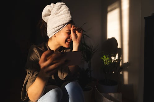 A woman laughs at Instagram DM messages in her "all messages" inbox.