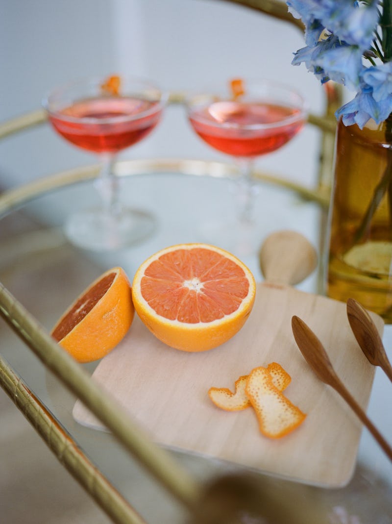 An instagrammable bar cart full of different kinds of liquor. A doctor explains what type of alcohol...