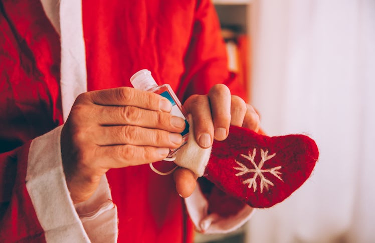A man is filling his stocking stuffer with a handy and sweet smelling holiday hand sanitizer