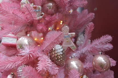 An out of the box pink Monochromic Palette plastic christmas tree with decorations on it
