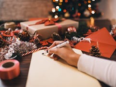 A woman wraps gifts and makes holiday crafts at home. 