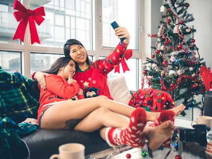 Two happy girls pose for a selfie in their holiday loungewear on Christmas morning.