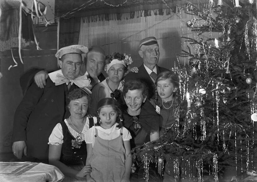 This vintage Christmas photo from 1938 shows a family near their tree.
