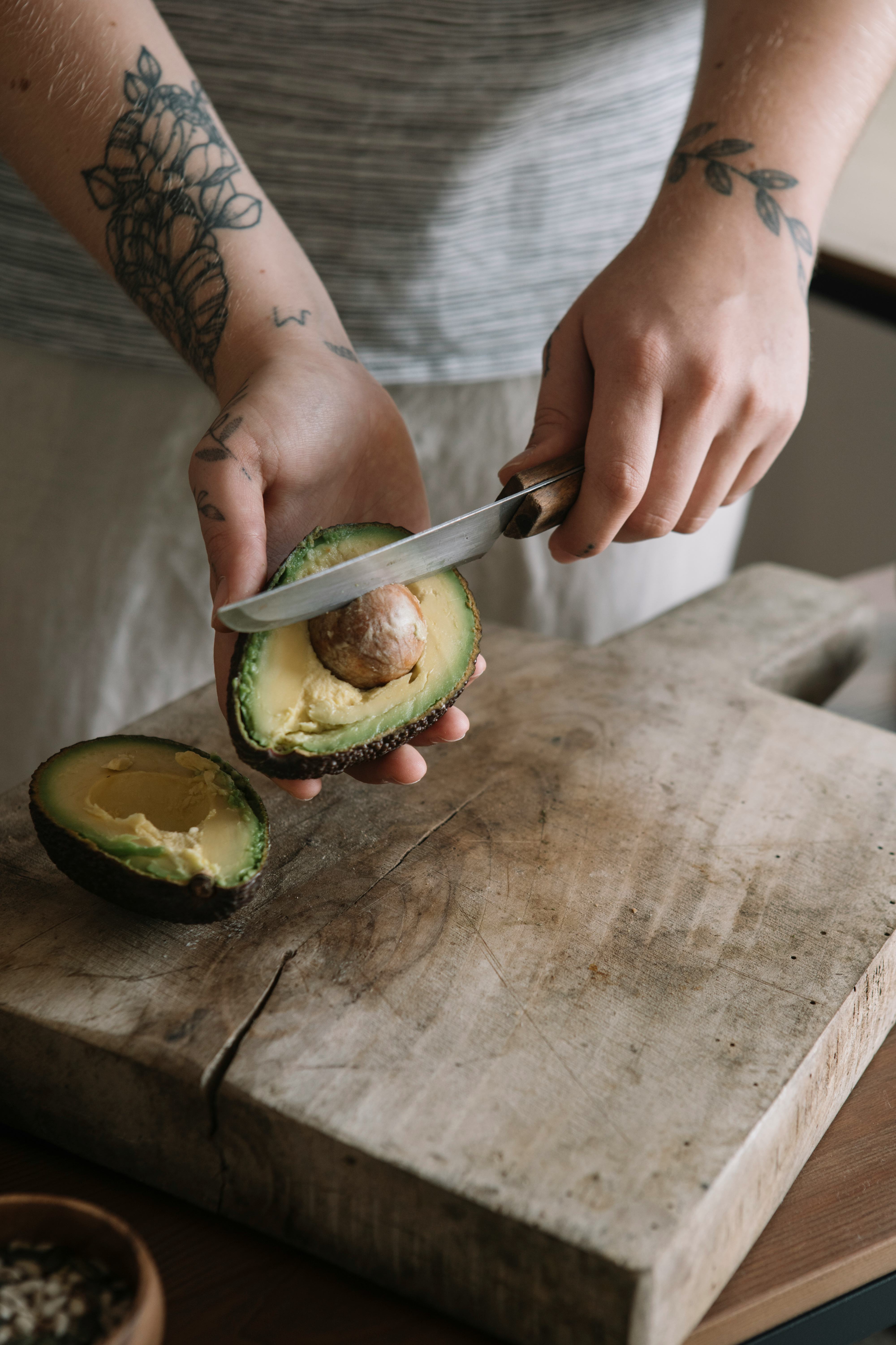 A woman cuts an avocado after a new study found that avocado can help your gut health.