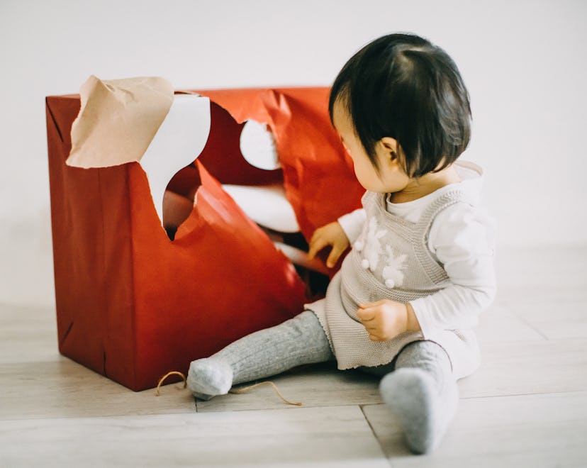 baby opening wrapping paper