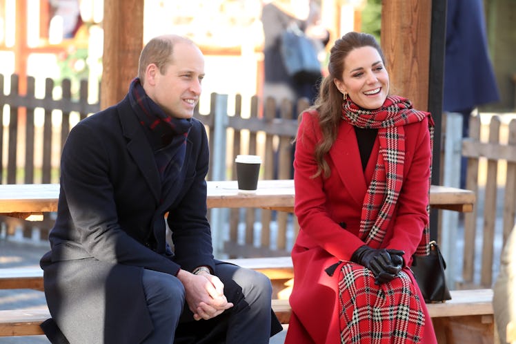 Prince William and Kate Middleton sit at a picnic table during the winter.
