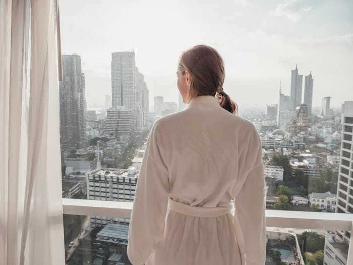 woman looking out window