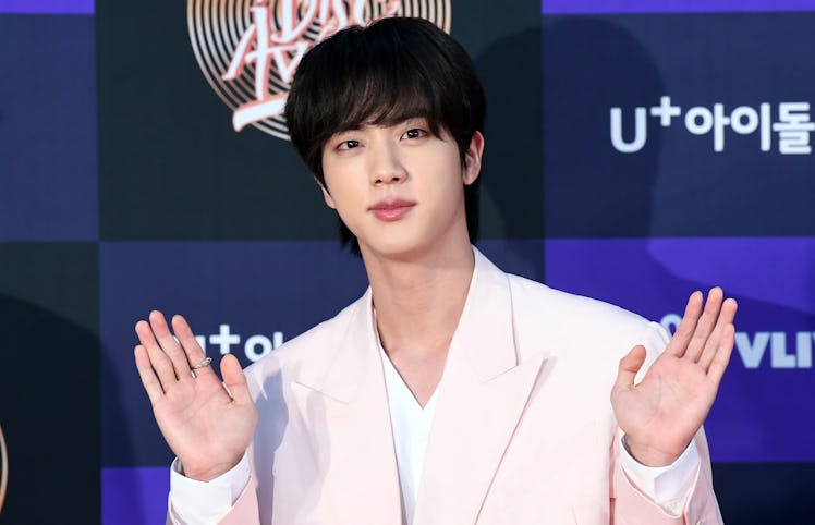 BTS' Jin waves to fans.