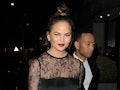 Chrissy Teigen steps out in a sheer lace shirt.