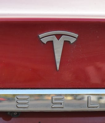 Tesla emblem on the back of a Model S electric car.