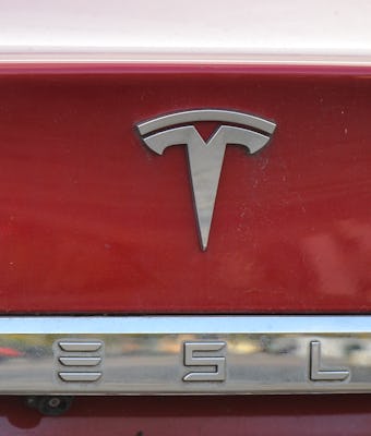 Tesla emblem on the back of a Model S electric car. 