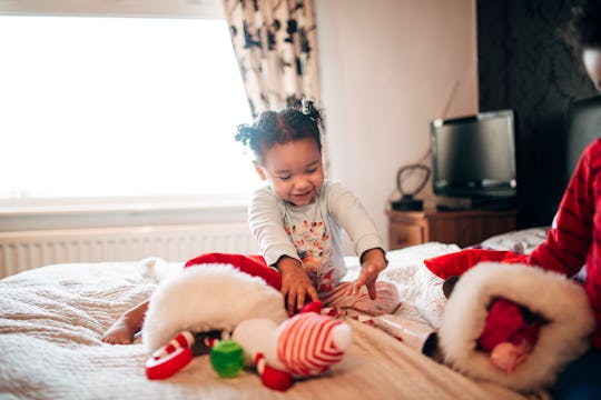 Little girl opening stockings.