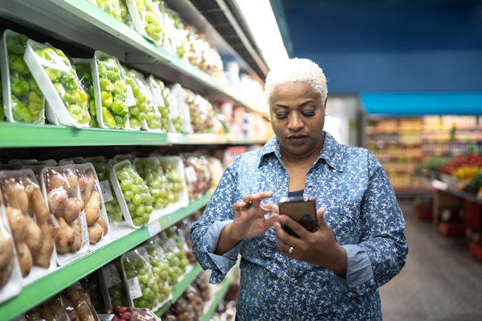 woman pulling up coupon on her phone